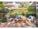 Stunning outdoor patio with comfortable seating, a fire pit, and views of lush greenery at 7117 E Rancho Vista Dr # 1012, Scottsdale, AZ 85251