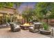 A tranquil patio features a stone fire pit surrounded by comfortable seating at 7117 E Rancho Vista Dr # 1012, Scottsdale, AZ 85251