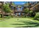 Beautiful green community putting green surrounded by lush landscaping and condos at 7117 E Rancho Vista Dr # 1012, Scottsdale, AZ 85251