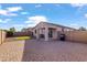 Paver patio with a built in covered patio area and a small patch of green artificial turf at 7305 W Darrel Rd, Laveen, AZ 85339