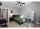 Bedroom featuring wood-look floors, ceiling fan, and modern décor at 7305 W Darrel Rd, Laveen, AZ 85339