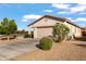 Single story home with a well manicured front yard and desert landscaping at 7305 W Darrel Rd, Laveen, AZ 85339