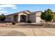 Inviting single-story home with neutral stucco and well-maintained desert landscaping at 7305 W Darrel Rd, Laveen, AZ 85339