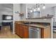 Open kitchen featuring stainless steel appliances and a breakfast bar at 7305 W Darrel Rd, Laveen, AZ 85339