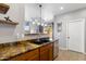 Bright kitchen with brown granite countertops, undermount sink, and stainless-steel appliances at 7305 W Darrel Rd, Laveen, AZ 85339