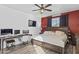 Cozy main bedroom with a large bed, ceiling fan, and modern decor at 7305 W Darrel Rd, Laveen, AZ 85339