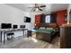 Bedroom with wood accent wall, ceiling fan, and dedicated desk area at 7305 W Darrel Rd, Laveen, AZ 85339
