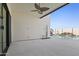An outdoor covered patio with ceiling fan, stone flooring and overlooks the pool with unique rock waterfall feature at 8503 S 9Th Dr # 17, Phoenix, AZ 85041