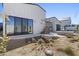 The landscaped backyard features a patio area, hot tub, pool and modern architectural home with metal stairs to deck at 8503 S 9Th Dr # 17, Phoenix, AZ 85041
