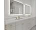 Bright bathroom featuring double vanity with backlit mirrors and elegant fixtures at 8503 S 9Th Dr # 17, Phoenix, AZ 85041