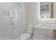 Modern bathroom featuring a white-tiled shower with glass door and a vanity with a light wood grain cabinet and white countertop at 8503 S 9Th Dr # 17, Phoenix, AZ 85041