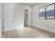 Bright bedroom with large window, hardwood floors, and walk-in closet at 8503 S 9Th Dr # 17, Phoenix, AZ 85041