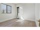 This bedroom features wood flooring, bright natural light, and a custom closet at 8503 S 9Th Dr # 17, Phoenix, AZ 85041