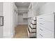 Bright walk-in closet with built-in shelves and drawers, providing ample storage space at 8503 S 9Th Dr # 17, Phoenix, AZ 85041