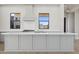 Gourmet kitchen featuring an island with stainless steel appliances, custom cabinets and a range hood at 8503 S 9Th Dr # 17, Phoenix, AZ 85041