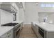 Gourmet kitchen featuring an island, stainless steel appliances, custom cabinets and light hardwood flooring at 8503 S 9Th Dr # 17, Phoenix, AZ 85041