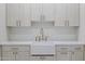 Bright laundry room featuring shaker cabinets, farmhouse sink, and stylish backsplash at 8503 S 9Th Dr # 17, Phoenix, AZ 85041