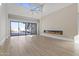 Bright open living room with a modern fireplace, tall ceilings, fan and glass patio doors at 8503 S 9Th Dr # 17, Phoenix, AZ 85041