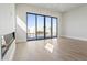 Bright living room with contemporary fireplace, recessed lights, and a large sliding glass door to the outdoor waterfall pool at 8503 S 9Th Dr # 17, Phoenix, AZ 85041