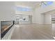 Bright, open living room featuring modern fireplace, high ceilings, and an open-concept kitchen with recessed lighting at 8503 S 9Th Dr # 17, Phoenix, AZ 85041