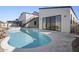 Backyard pool and hot tub with rock waterfall feature, accented by the exterior stairs and sliding doors to home at 8503 S 9Th Dr # 17, Phoenix, AZ 85041