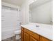 Bright bathroom featuring a wood vanity, shower-tub combo, and modern fixtures at 8723 E Kiowa Ave, Mesa, AZ 85209