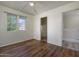 Bedroom with ceiling fan, wood floors, and natural light from windows; stairway leading to another floor at 8723 E Kiowa Ave, Mesa, AZ 85209