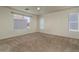 Spacious carpeted bedroom with a ceiling fan and bright natural light from multiple windows at 8723 E Kiowa Ave, Mesa, AZ 85209