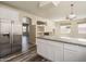 Open concept kitchen with granite island, stainless steel refrigerator, and hardwood floors at 8723 E Kiowa Ave, Mesa, AZ 85209