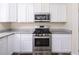 Kitchen with stainless steel appliances, granite countertops, white cabinets, and hardwood flooring at 8723 E Kiowa Ave, Mesa, AZ 85209