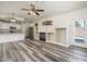 Spacious living room with hardwood floors, fireplace, and open access to the kitchen at 8723 E Kiowa Ave, Mesa, AZ 85209