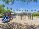Community playground with swings, slides, and climbing structures surrounded by trees and landscaping at 8723 E Kiowa Ave, Mesa, AZ 85209