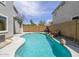 A backyard pool with rock accents and an in-ground spa, surrounded by privacy fencing and lush landscaping at 8723 E Kiowa Ave, Mesa, AZ 85209