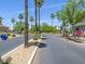 Neighborhood street view featuring a landscaped median with mature shade trees and community signage at 8723 E Kiowa Ave, Mesa, AZ 85209