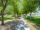 Scenic walkway lined with lush trees and landscaping invites leisurely strolls and outdoor activities at 8723 E Kiowa Ave, Mesa, AZ 85209