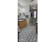 Bathroom with patterned floors, wooden vanity, and glass-enclosed shower at 8902 E Baltimore St, Mesa, AZ 85207