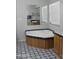 Bright bathroom features a soaking tub with stylish patterned flooring at 8902 E Baltimore St, Mesa, AZ 85207