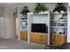 Living room featuring custom built-in shelves and cabinets for storage and media, enhancing functionality and style at 8902 E Baltimore St, Mesa, AZ 85207