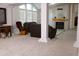 Spacious living room with a fireplace, neutral carpet, and vaulted ceilings provides a cozy gathering space at 8902 E Baltimore St, Mesa, AZ 85207