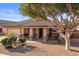 Inviting single-story home with covered porch, desert landscaping and cozy sitting area at 9632 E Olla Ave, Mesa, AZ 85212
