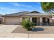 Well-maintained home with a two-car garage, covered porch, and attractive desert landscaping for enhanced curb appeal at 9632 E Olla Ave, Mesa, AZ 85212