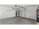 Spacious two car garage with white door, storage cabinets, and concrete floors at 9632 E Olla Ave, Mesa, AZ 85212