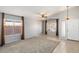 Bright living room featuring large windows, neutral carpet, tile entryway, and high ceilings offering spaciousness at 9632 E Olla Ave, Mesa, AZ 85212