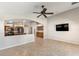 An open concept living room that flows into the kitchen with a ceiling fan at 9632 E Olla Ave, Mesa, AZ 85212
