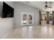 Open living room with tile flooring, ceiling fan and access to the backyard at 9632 E Olla Ave, Mesa, AZ 85212