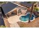 Inviting backyard pool with surrounding patio, palm tree, and desert landscaping for relaxation and outdoor enjoyment at 9632 E Olla Ave, Mesa, AZ 85212