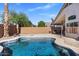 Backyard with refreshing pool and covered patio with outdoor furniture and brick wall at 9632 E Olla Ave, Mesa, AZ 85212