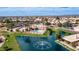 Community clubhouse and pool with a fountain, surrounded by lush landscaping and serene waterways at 10377 W Yukon Dr, Peoria, AZ 85382