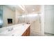 Well-lit main bathroom with dual sinks, wood cabinets, and glass shower doors at 10377 W Yukon Dr, Peoria, AZ 85382