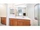 Spacious main bathroom with dual sinks, wood cabinets, and glass shower doors at 10377 W Yukon Dr, Peoria, AZ 85382
